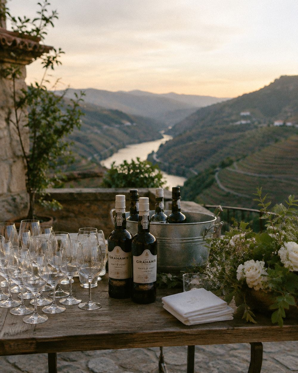Glasses of white port on a quinta terrace above the Douro Valley